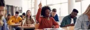 student raising hand in class